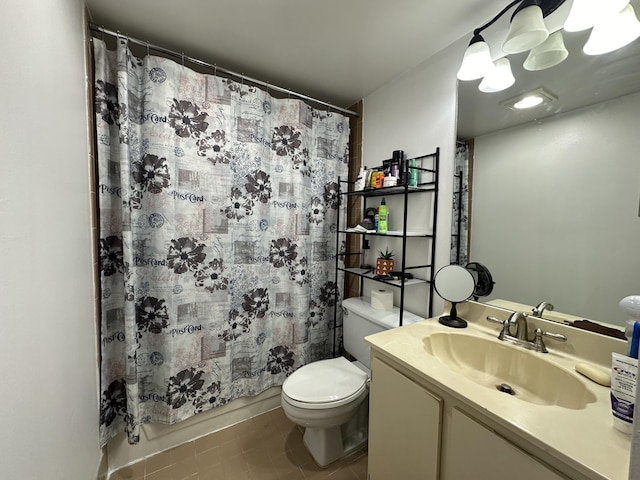 bathroom with tile patterned floors, vanity, and toilet