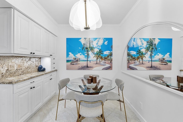 tiled dining room featuring ornamental molding