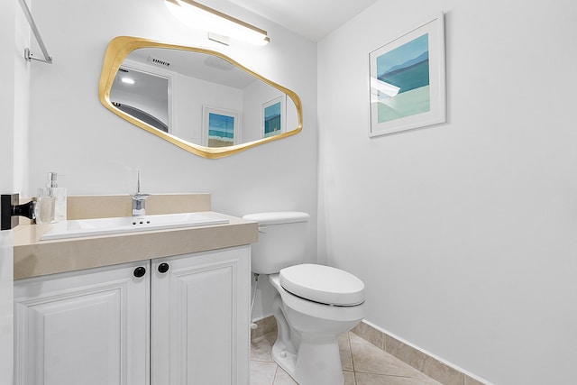 bathroom with tile patterned flooring, vanity, and toilet