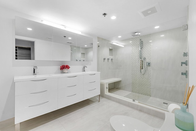 bathroom with vanity and a shower with shower door