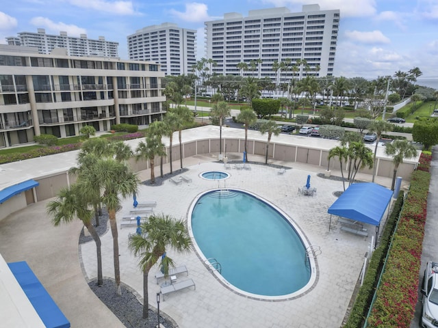 view of pool with a patio area and a hot tub