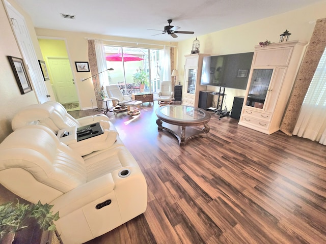 living room with ceiling fan and dark wood-type flooring