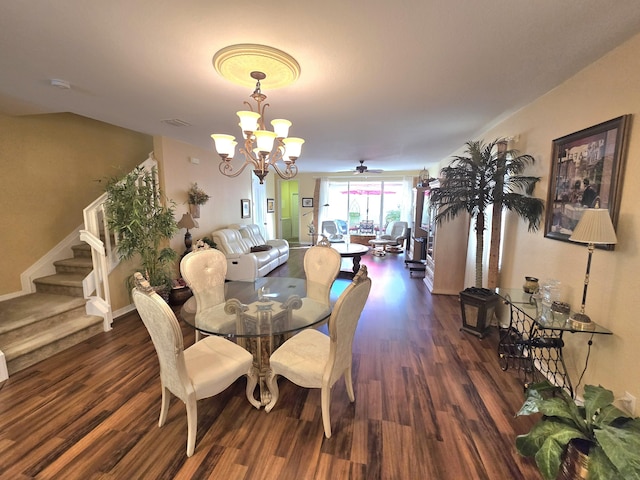 dining area with dark hardwood / wood-style flooring and ceiling fan with notable chandelier