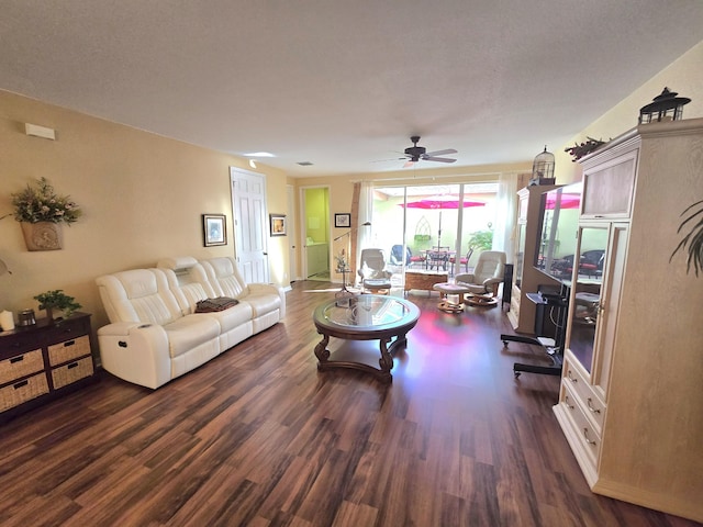 living room with ceiling fan and dark wood-type flooring