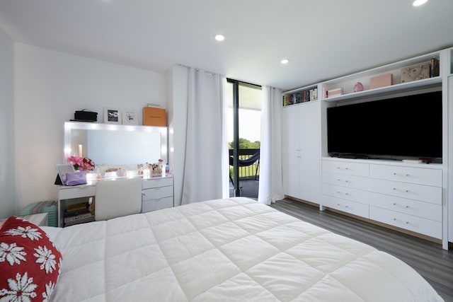 bedroom featuring access to exterior, hardwood / wood-style floors, and floor to ceiling windows