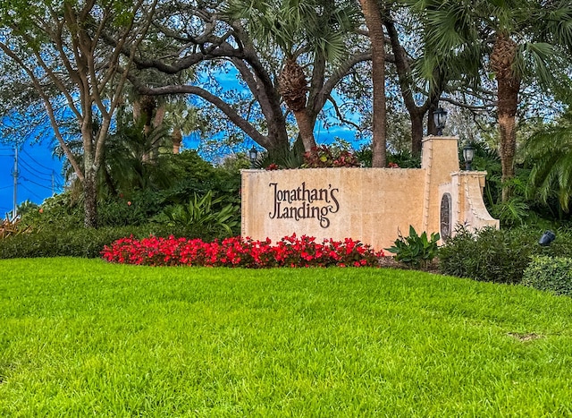 community / neighborhood sign with a lawn