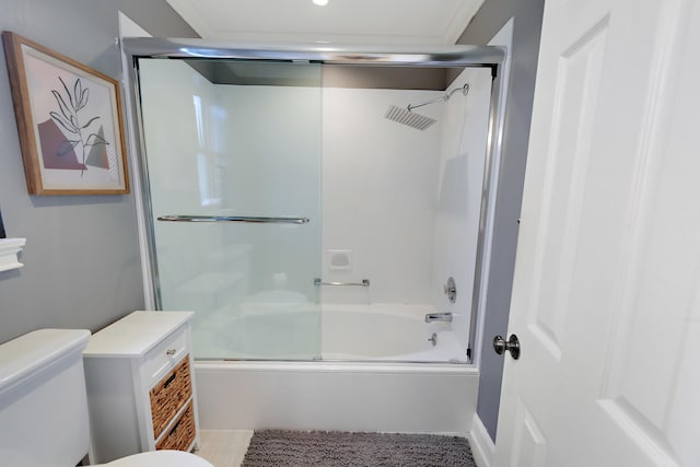 bathroom with toilet and bath / shower combo with glass door