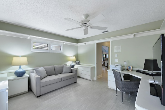 office space featuring a textured ceiling and ceiling fan