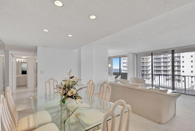 dining space featuring a textured ceiling and expansive windows