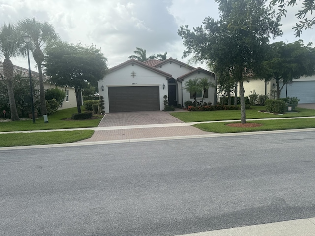 view of front of home with a garage and a front lawn