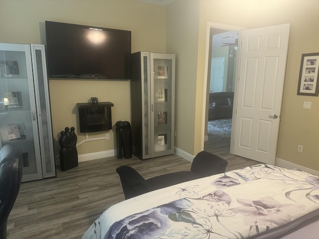 bedroom with connected bathroom and dark hardwood / wood-style floors