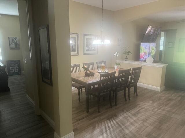 dining area featuring a chandelier and dark hardwood / wood-style flooring