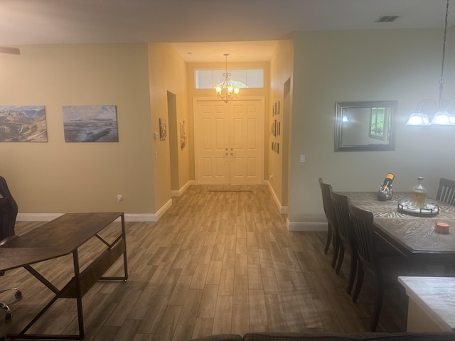 entrance foyer featuring a chandelier and hardwood / wood-style flooring