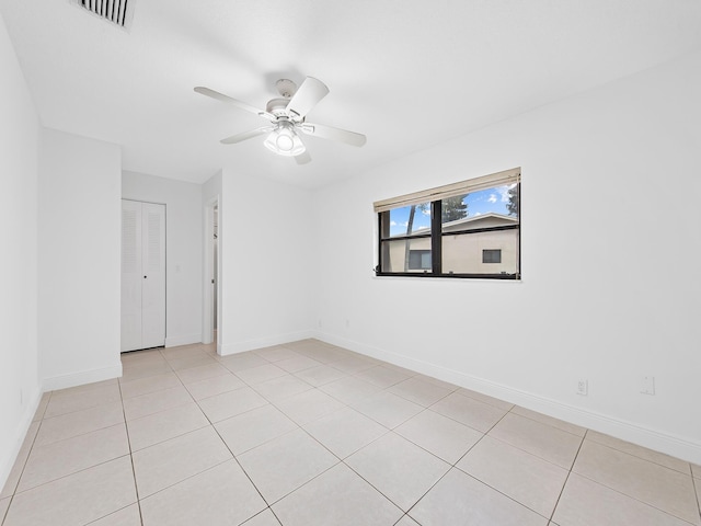 unfurnished room featuring ceiling fan and light tile patterned floors