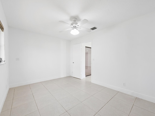 spare room featuring ceiling fan and light tile patterned flooring