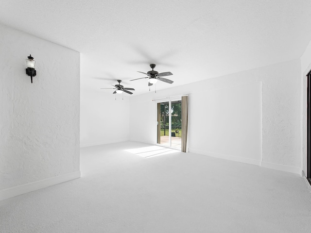 spare room featuring carpet flooring and ceiling fan