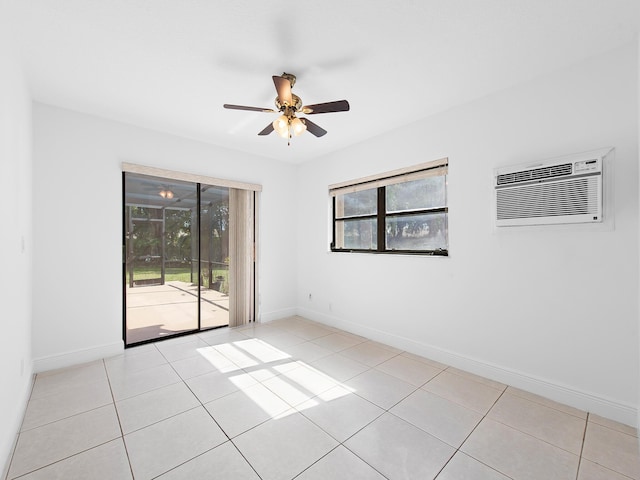 tiled empty room featuring ceiling fan and an AC wall unit