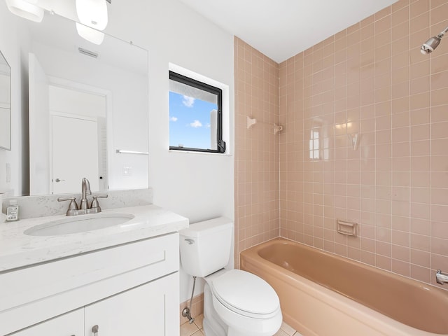 full bathroom with toilet, vanity, and tiled shower / bath