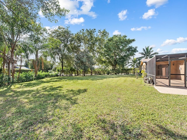 view of yard with a lanai