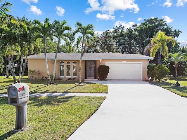 single story home with a front yard and a garage