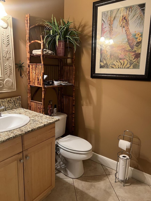 bathroom featuring tile patterned floors, vanity, and toilet