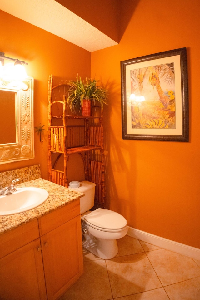 12858 153rd Ct N, Jupiter, FL 33478 - half bathroom with tile patterned floors, baseboards, toilet, and vanity