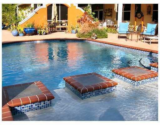 view of pool with a hot tub and a patio