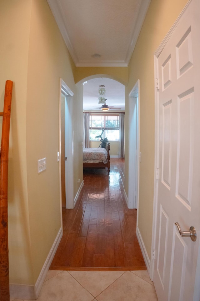 12858 153rd Ct N, Jupiter, FL 33478 - corridor featuring light wood-style floors, crown molding, arched walkways, and baseboards