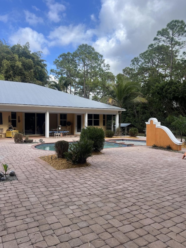 rear view of property featuring a patio