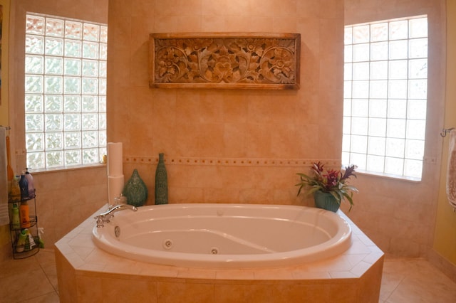 12858 153rd Ct N, Jupiter, FL 33478 - bathroom featuring tile patterned floors, a jetted tub, and tile walls
