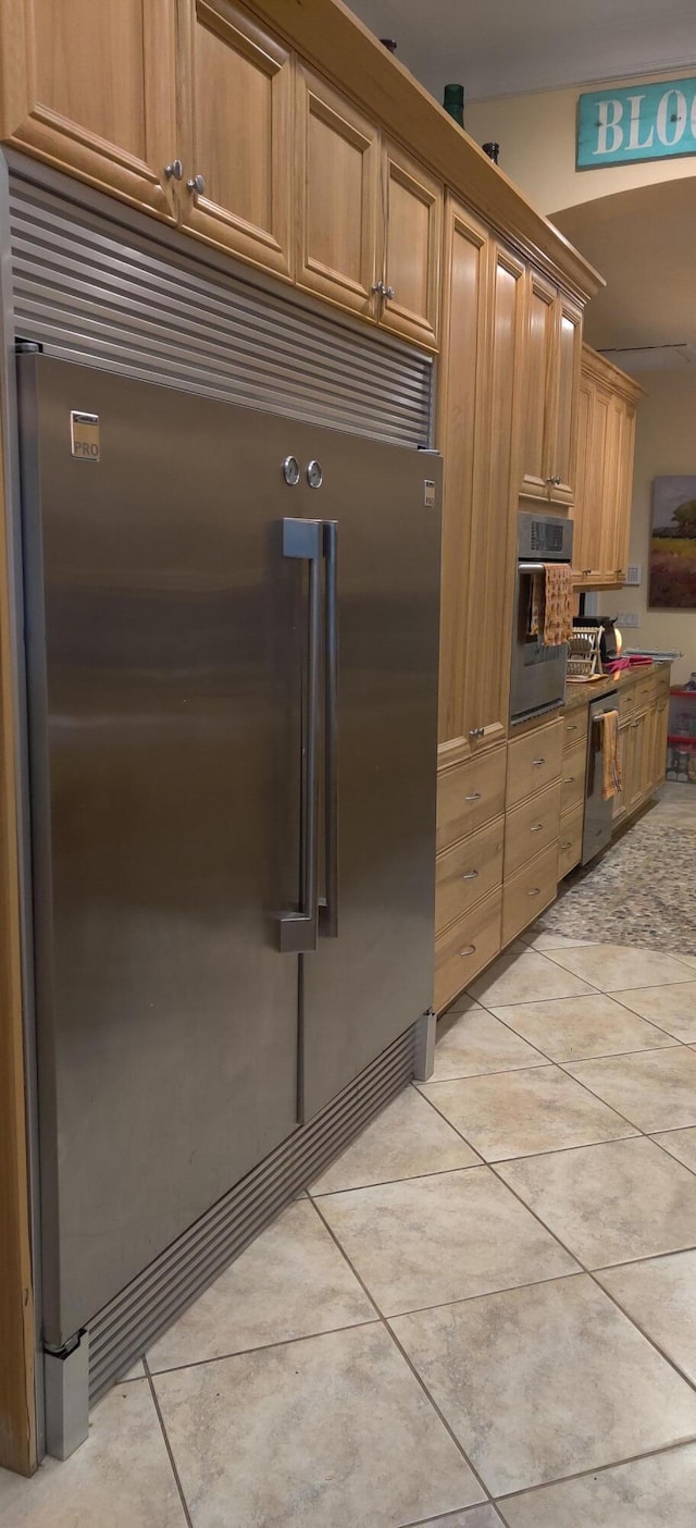 kitchen featuring light tile patterned flooring and appliances with stainless steel finishes