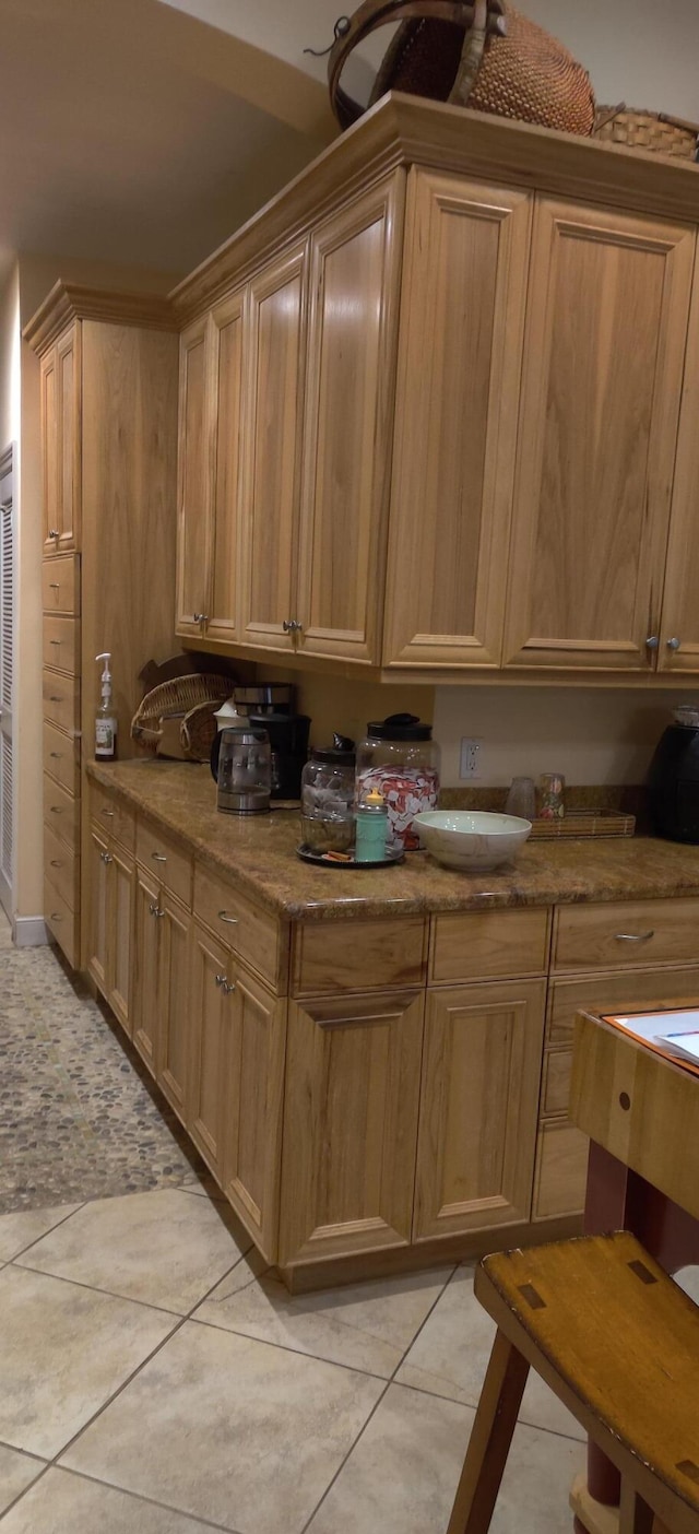 kitchen with light stone counters and light tile patterned flooring