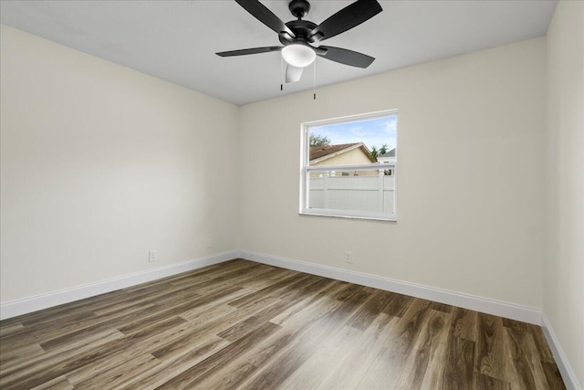 empty room with ceiling fan and hardwood / wood-style floors