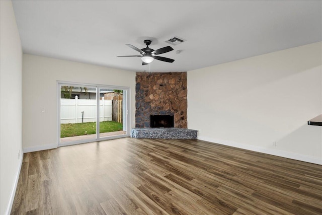 unfurnished living room with ceiling fan, hardwood / wood-style floors, and a fireplace