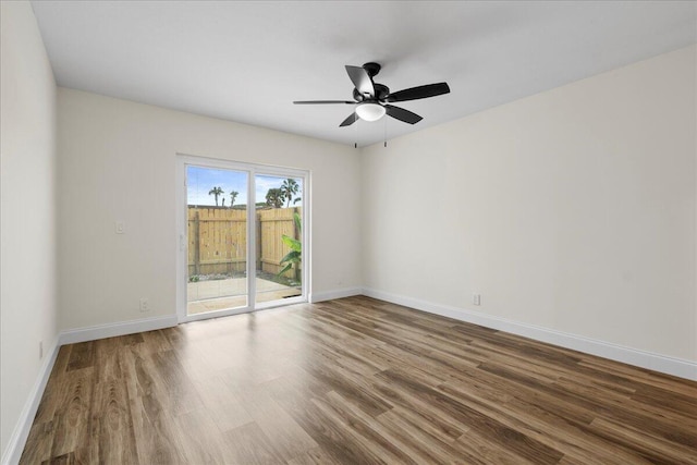 empty room with ceiling fan and hardwood / wood-style flooring