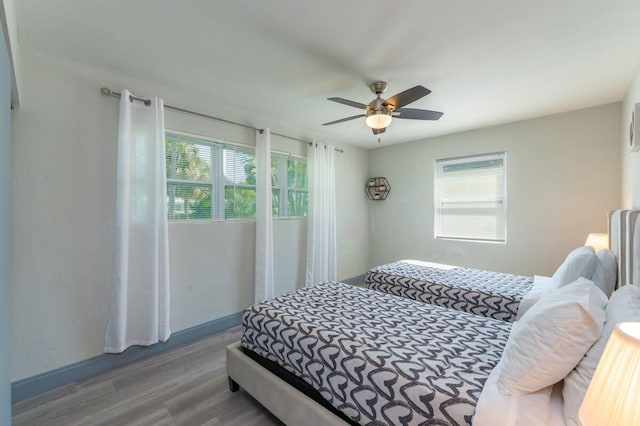 bedroom with light hardwood / wood-style floors and ceiling fan