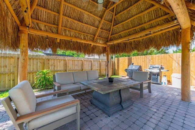 view of patio featuring a gazebo, area for grilling, and an outdoor living space with a fire pit