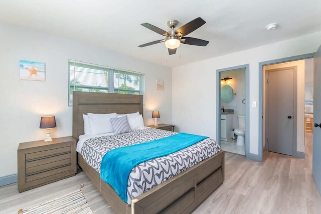 bedroom with ensuite bathroom, ceiling fan, and light wood-type flooring