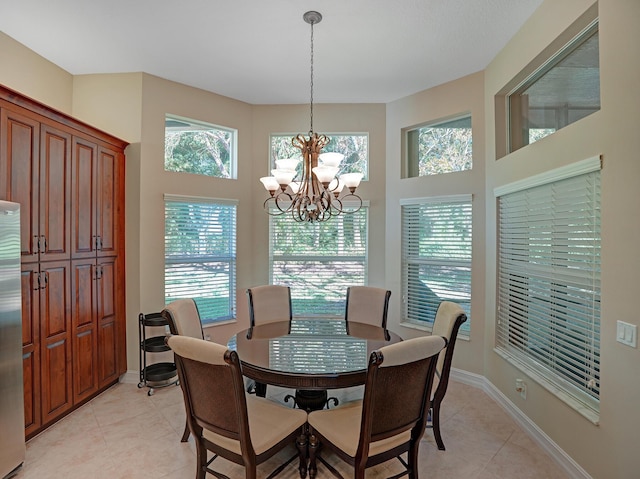 tiled dining area with a chandelier