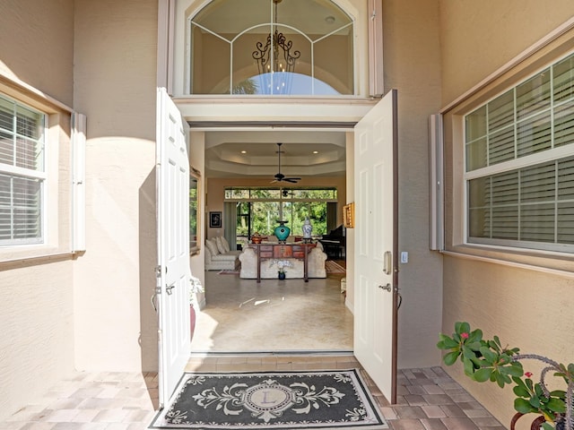 view of exterior entry with ceiling fan