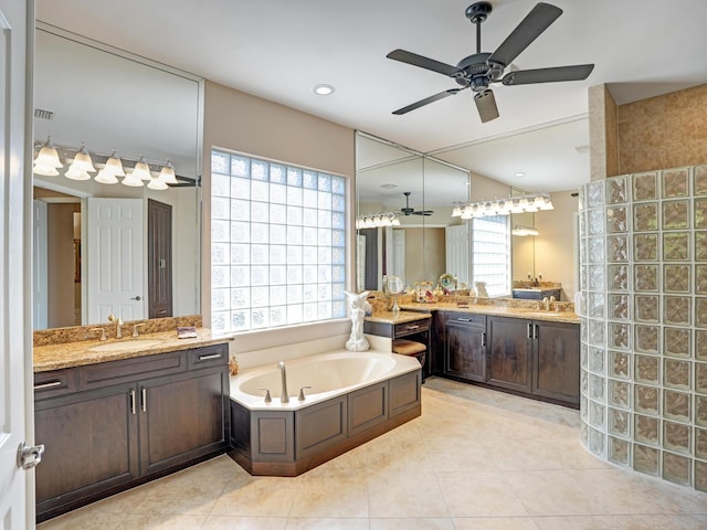 bathroom featuring tile patterned flooring, vanity, and a tub