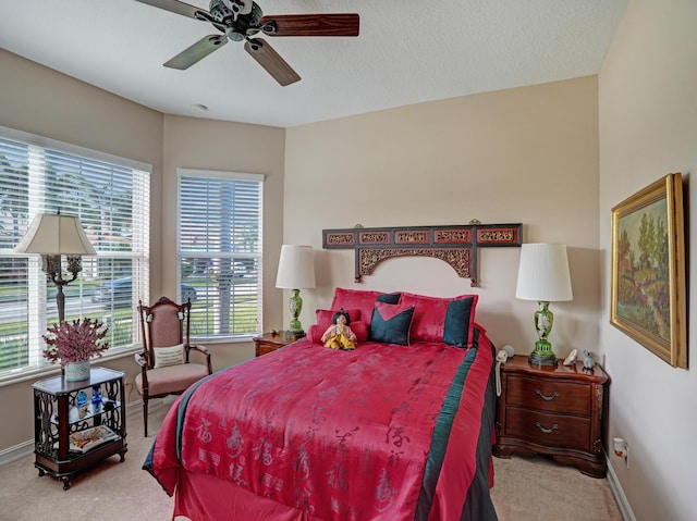 bedroom with light colored carpet and ceiling fan