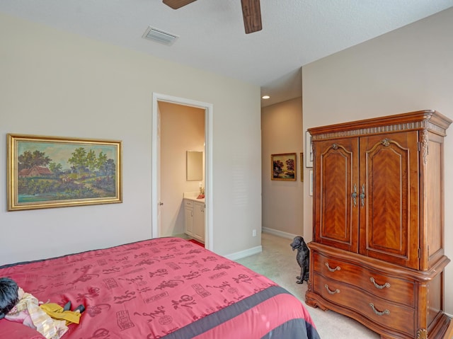 carpeted bedroom with ceiling fan and ensuite bath