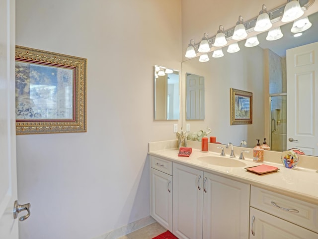 bathroom featuring tile patterned flooring, vanity, and walk in shower