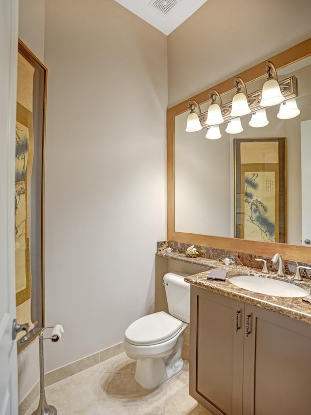 bathroom with tile patterned flooring, vanity, and toilet