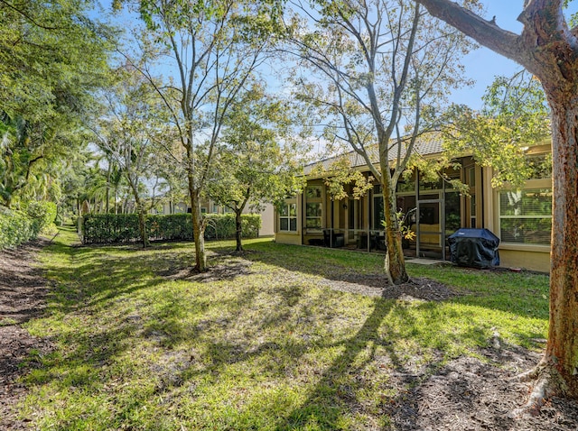 view of yard featuring a sunroom