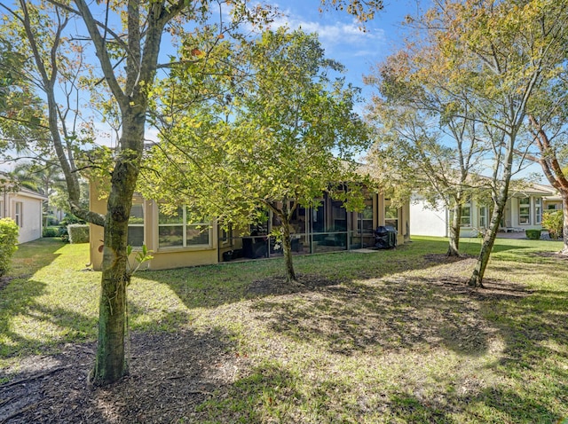 view of yard featuring a sunroom