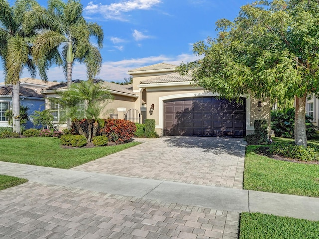 view of front of home with a garage and a front lawn