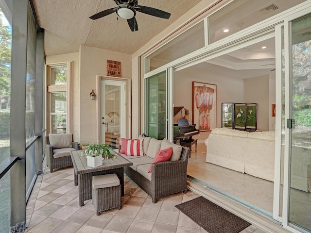 sunroom / solarium featuring ceiling fan