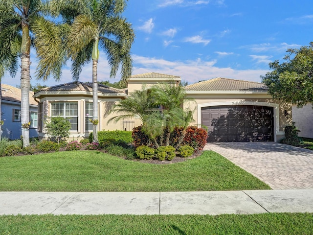 view of front of home with a front yard and a garage